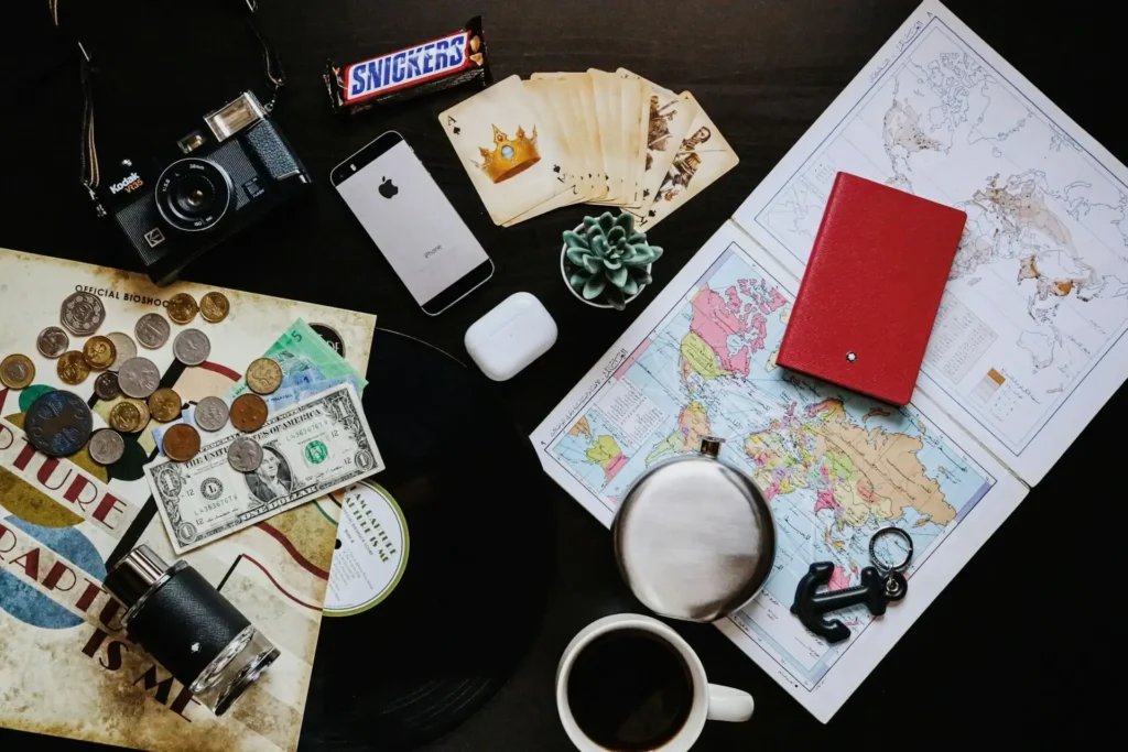 Traveler planning an outdoor adventure trip using a map and travel journal
